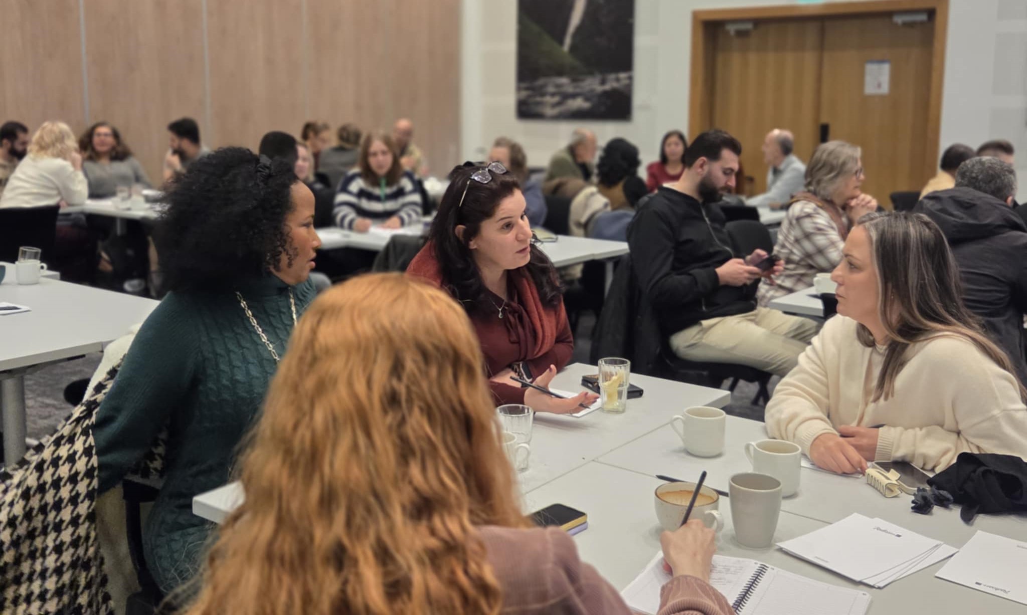 En gruppe mennesker som sitter ved bord