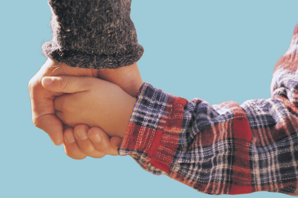 Eit barn held hender med ein vaksen.