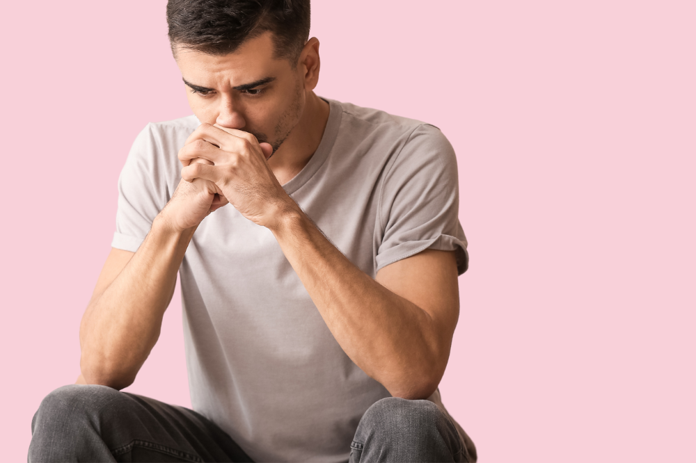 Ein mann som sit med hendene på haka.