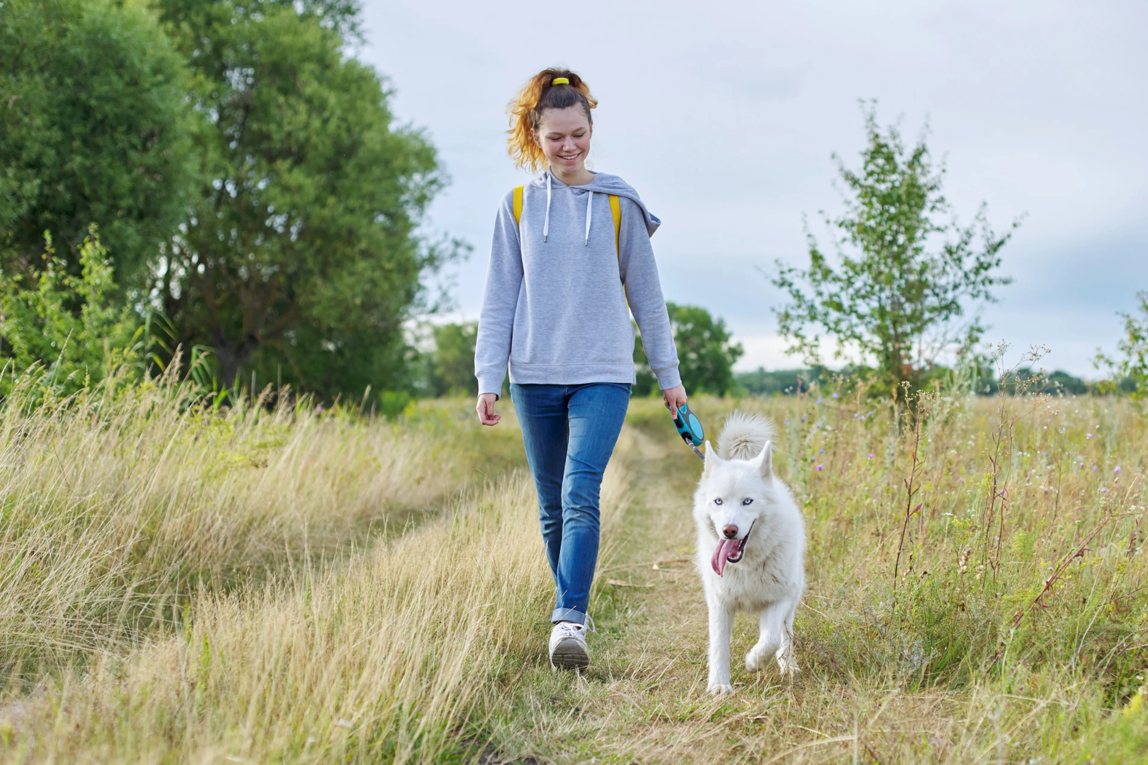 Ei ung kvinne som går tur med ein hund