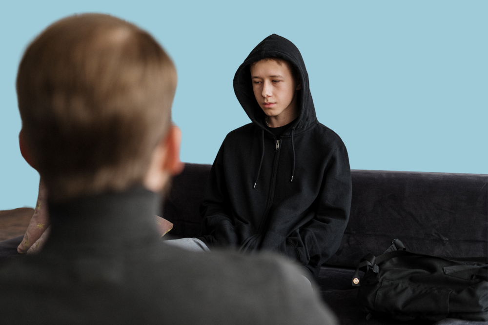 Ein ungdom i svart hettegensar